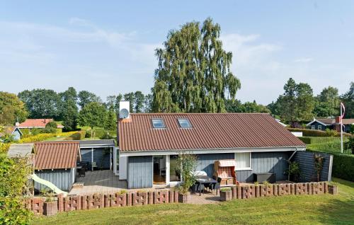 a house with a red roof and a yard at Stunning Home In Hejls With Sauna in Hejls