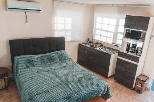 a kitchen with a bed and a stove top oven at Klip lagoon apartsments in Oranjestad