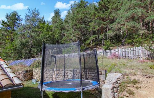 a trampoline in a yard next to a fence at Lovely Home In Saint Etienne De Serre in Saint-Étienne-de-Serres