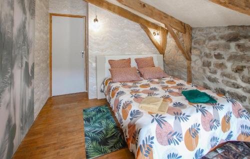 a bedroom with a bed and a stone wall at Lovely Home In Saint Etienne De Serre in Saint-Étienne-de-Serres