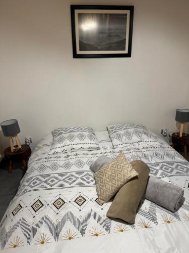 a bed with two pillows on it in a bedroom at Le Chalet du Bonheur à Soucht in Soucht