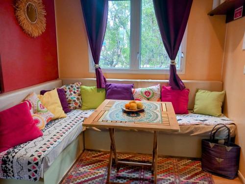 a living room with a couch and a table at Koala Valdareina, Piscine chauffée, Bénagil-Carvoeiro in Carvoeiro