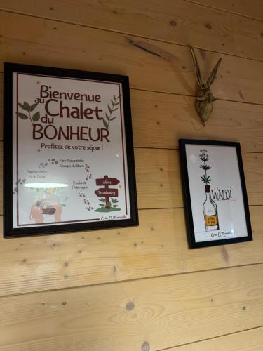 a picture of a bottle of wine on a wall at Le Chalet du Bonheur à Soucht in Soucht