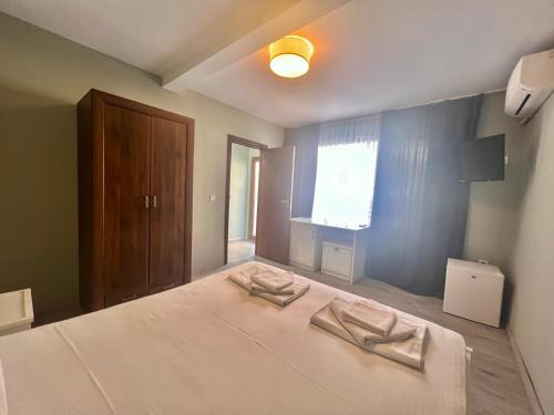 a bedroom with a bed with two towels on it at Kiara Apartments in Saints Constantine and Helena