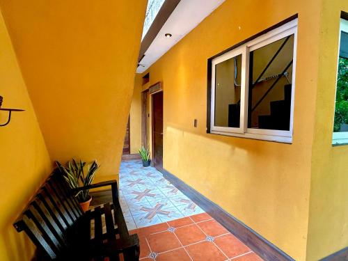 a hallway with a bench and a window at Hotel San Miguel in Flores