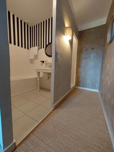 a bathroom with a sink and a toilet in a room at MAISON DE MARQUAY-MAISON D'HOTES in Marquay