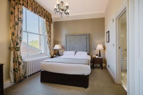 a bedroom with a large bed and a window at Winchester Royal Hotel in Winchester