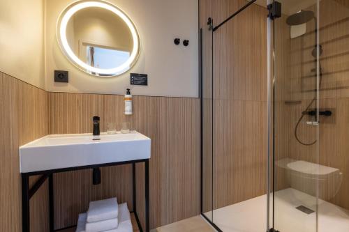 a bathroom with a sink and a shower at Hôtel Brady in Paris