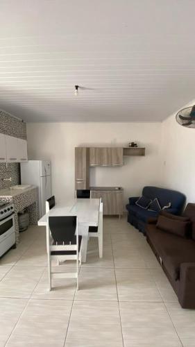 a living room with a table and a couch at Apartamentos L & L in Rio Grande