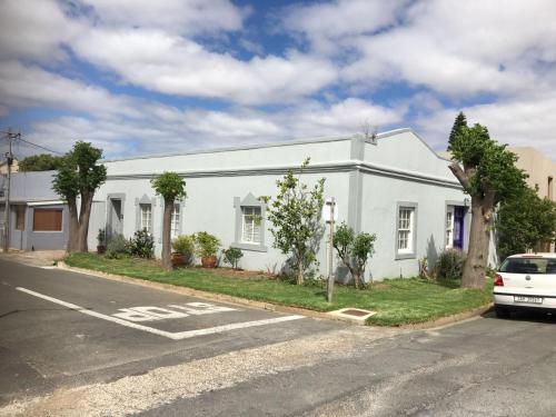 a white building on the side of a street at The Pink Door in Caledon