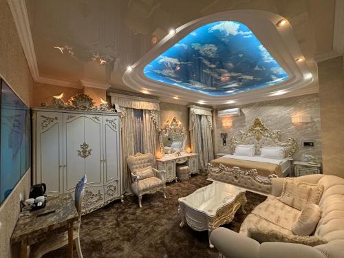 a bedroom with a large bed with a large painting on the ceiling at Hotel Agava in Tbilisi City