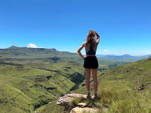 a woman standing on top of a mountain at Sani Lodge & Cottages in Sani Pass