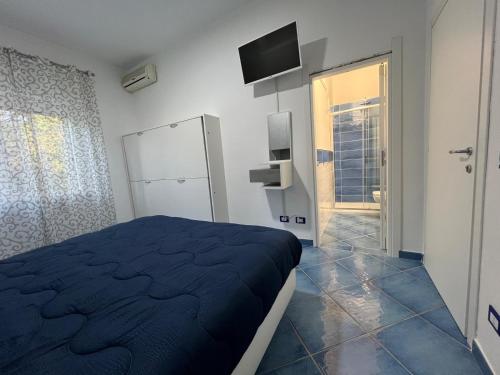 a bedroom with a bed and a television on the wall at Casa Vacanza IMPARO B&B Ischia in Ischia