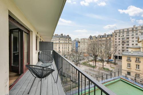 un balcon avec un banc et une vue sur une ville dans l'établissement Bluestay 53 - Appartement Chic au Cœur de Paris, à Paris