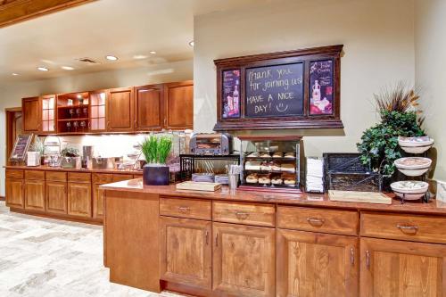 a large kitchen with wooden cabinets and a counter at Homewood Suites by Hilton Richland in Richland