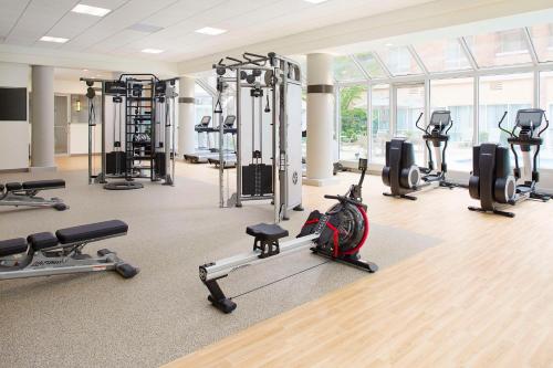 a gym with several treadmills and exercise bikes at Hilton Atlanta Perimeter Suites in Atlanta