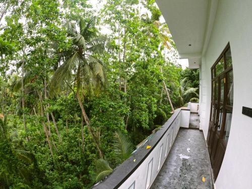a balcony of a house with trees and plants at Wijaya Villa in Habaraduwa