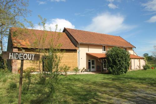 a house with a sign in front of it at Relax in this privately located farmhouse in Cossaye