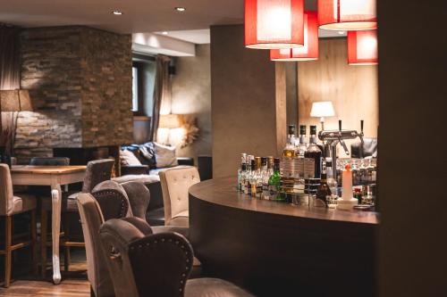 a bar in a restaurant with a table and chairs at Marienhöh - Hideaway & Spa in Langweiler