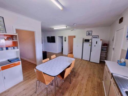 a kitchen and dining room with a table and chairs at Howsthaserenitee - 3BR house with bay views in Coffin Bay