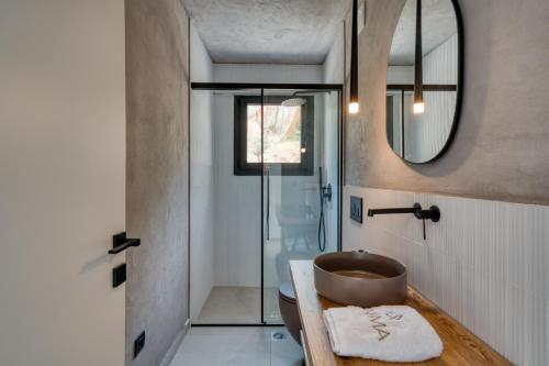 a bathroom with a wooden sink and a mirror at Anima Deluxe Suites in Nafplio