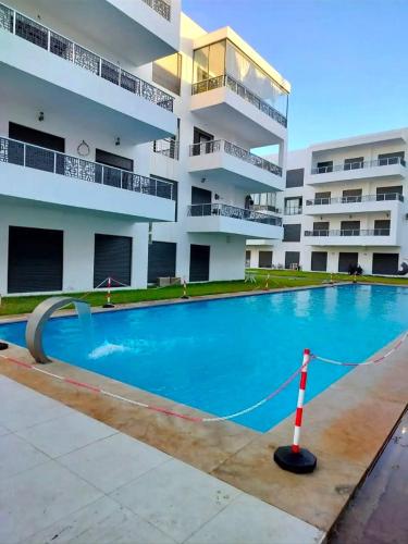 a large swimming pool in front of a building at Appartamento con piscina privata in Pont Blondin