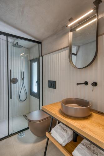a bathroom with a sink and a tub and a shower at Anima Deluxe Suites in Nafplio