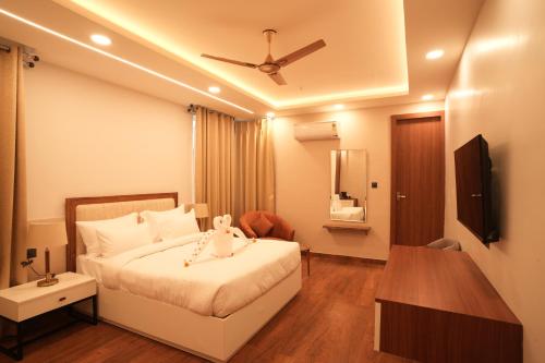 a bedroom with a bed with a ceiling fan at Alokah Kashi in Varanasi