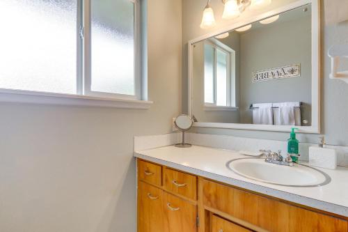 a bathroom with a sink and a mirror at 1 Mi to Snoqualmie River Pet-Friendly Home! in Pleasant Hill