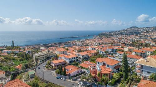 an aerial view of a town next to the ocean at Flowers island house 5 in Funchal