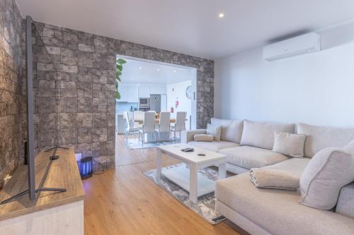 a living room with a couch and a table at Flowers island house 5 in Funchal
