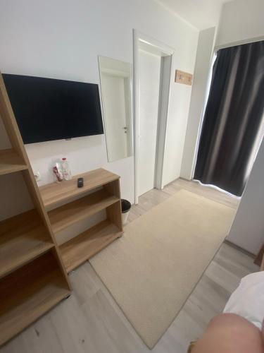 a living room with a flat screen tv on the wall at Hotel FOCUS in Prilep