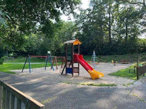 a playground with a slide in a park at Byt apartman 72m2 private garden PARKING FREE in Prague