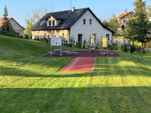 a large white building with a playground in a field at Byt apartman 72m2 private garden PARKING FREE in Prague
