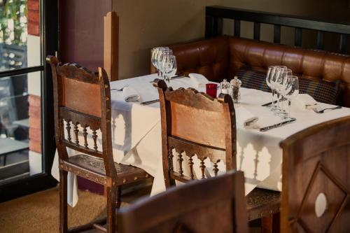 a table with wine glasses on top of it at Hôtel Ville d'Hiver in Arcachon