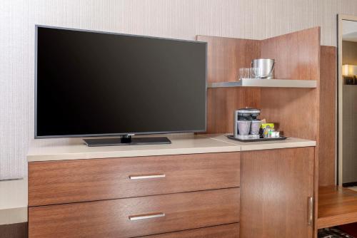 a flat screen tv sitting on top of a wooden entertainment center at DoubleTree by Hilton San Bernardino in San Bernardino