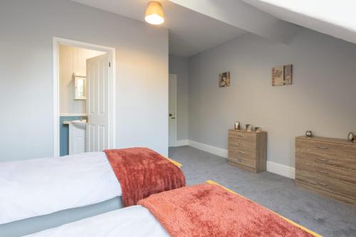 a bedroom with a bed and a wooden dresser at Host & Stay - Chatsworth Townhouse I in Carlisle