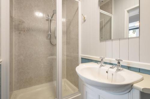 a white bathroom with a sink and a shower at Host & Stay - Chatsworth Townhouse I in Carlisle