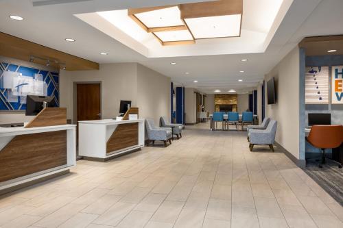a lobby of a hospital with chairs and tables at Holiday Inn Express Hotel & Suites Hagerstown by IHG in Hagerstown