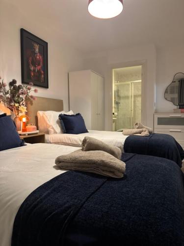 a bedroom with two beds with towels on them at Bromley jefersons place in Bromley
