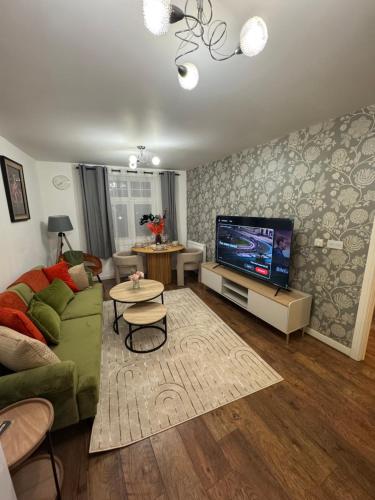 a living room with a couch and a flat screen tv at Bromley jefersons place in Bromley
