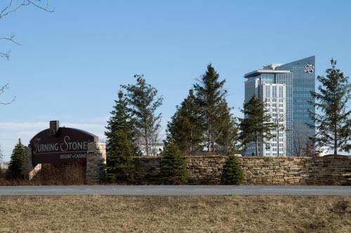 a sign for the hunting grove development with a fence and buildings at Fairfield Inn & Suites by Marriott Verona in Verona