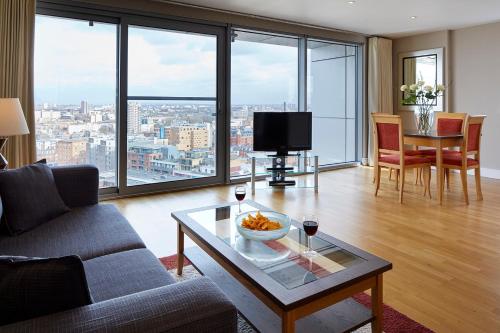 a living room with a couch and a table at Marlin Aldgate Tower Bridge in London