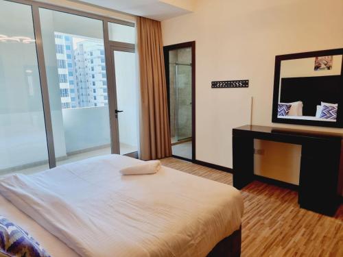 a bedroom with a large bed and a mirror at Aspire Tower # 7th Floor 2 Bhk Paradise Suite in Manama