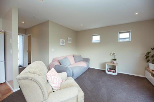 a living room with a couch and a chair at Alpine Nook in Methven