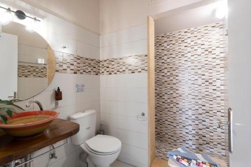 a bathroom with a toilet and a sink at Kalamata Art Rooms in Kalamata
