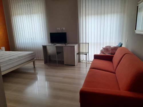 a living room with a couch and a desk with a television at Sunlight Suite in Termoli