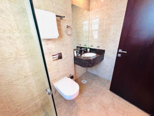 a bathroom with a toilet and a sink at Aspire Tower-The Tranquil Haven in Manama