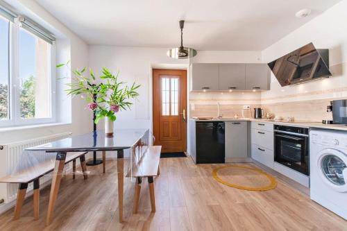a kitchen with a table and a dining room at Le Cocon in Condrieu