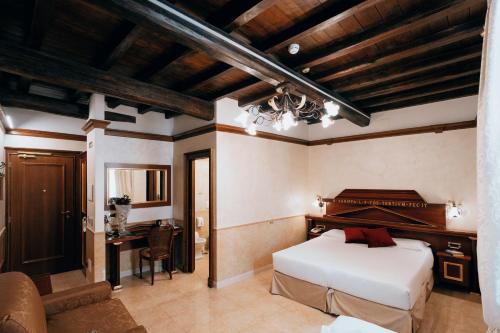 a bedroom with a bed and a desk in a room at Hotel Pantheon in Rome